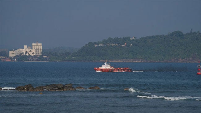 Coast Guard personnel clean up oil spillage in seas off Hikkaduwa